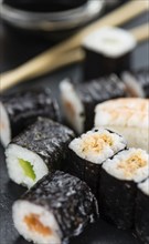 Fresh made Sushi (selective focus) on a vintage looking slate slab