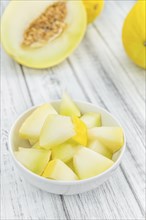 Honeydew Melon on an old wooden table as detailed close-up shot (selective focus)