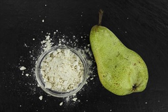 Fresh made Pear powder on a slate slab (close-up shot, selective focus)