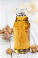 Portion of fresh Caramel Sirup (close-up shot, selective focus)