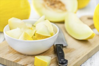 Honeydew Melon on an old wooden table as detailed close-up shot (selective focus)