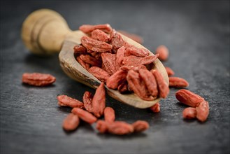 Fresh made Dried Goji Berries on a vintage background (close-up shot)