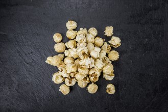 Some Popcorn on a slate slab as detailed close-up shot, selective focus