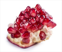 Portion of Pomegranate (as close-up shot) isolated on white background