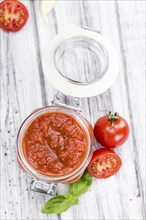 Pasta Sauce (Tomato taste) as high detailed close-up shot on a vintage wooden table (selective