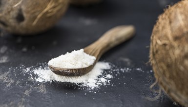 Healthy Coconut flour on a vintage slate slab (close-up shot, selective focus)