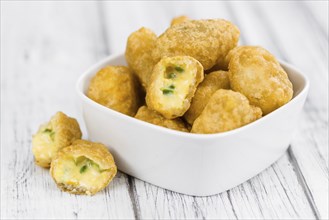 Chili Cheese Nuggets on a vintage background as detailed close-up shot (selective focus)