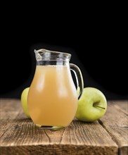 Apple Juice on a vintage background as detailed close-up shot (selective focus)