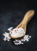 Portion of Himalayan Salt on a rustic slate slab (selective focus, close-up shot)