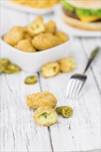 Homemade Cheese Nuggets (with Chilis) on vintage background (selective focus, close-up shot)