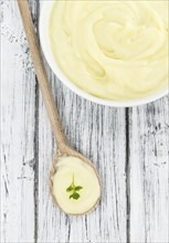 Potato Mash on rustic wooden background (close-up shot)