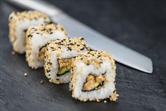 Slate slab with some Sushi (selective focus, close-up shot)