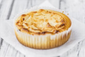 Fresh made Mini Cheesecake on an old and rustic wooden table (selective focus, close-up shot)