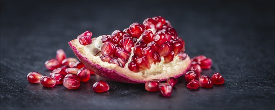 Pomegranate on a vintage background as detailed close-up shot (selective focus)