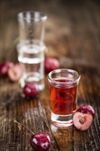 Some homemade Cherry Liqueur as detailed close-up shot, selective focus