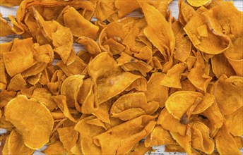 Sweet Potato Chips on a vintage background as detailed close-up shot, selective focus