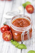 Fresh made Pasta Sauce (Tomato taste) on a vintage background (close-up shot)