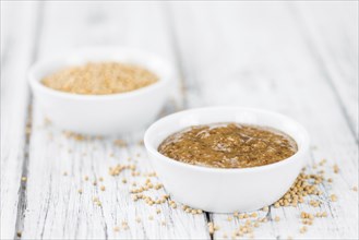 Fresh made German Cuisine (sweet Mustard) on a vintage background (close-up shot)