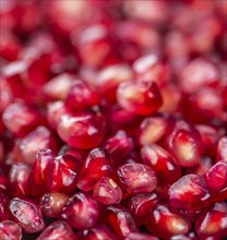 Pomegranate on a vintage background as detailed close-up shot (selective focus)