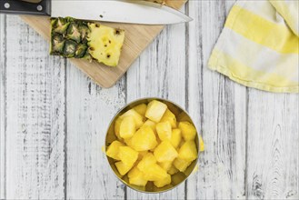 Fresh made Pineapple (sliced) on a vintage background as detailed close-up shot