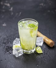 Slate slab with Caipirinha (selective focus, close-up shot)