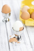 Wooden table with boiled Eggs (selective focus, close-up shot)