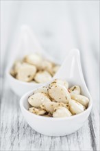 Portion of fresh Preserved Garlic (close-up shot, selective focus)