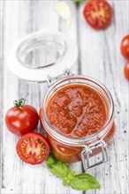 Fresh made Pasta Sauce (Tomato taste) on a vintage background (close-up shot)