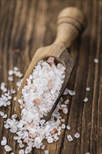 Himalayan Salt as high detailed close-up shot on a vintage wooden table (selective focus)