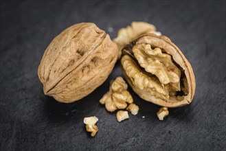 Walnuts on a vintage background as detailed close-up shot (selective focus)