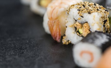 Fresh made Sushi (selective focus) on a vintage looking slate slab