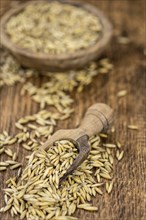 Old wooden table with fresh Oat (close-up shot, selective focus)