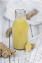 Portion of healthy Ginger Drink (selective focus, close-up shot)