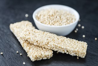 Some Quinoa Bars on a slate slab (close-up shot, selective focus)