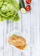 Old wooden table with a Chicken Schnitzel (selective focus, close-up shot)