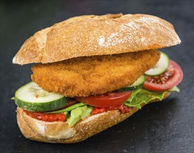 Slate slab with a Chicken Schnitzel (close-up shot, selective focus)