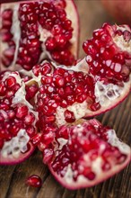 Pomegranate on a vintage background as detailed close-up shot (selective focus)