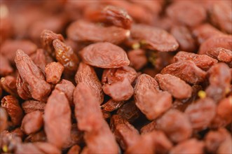 Goji Berries (dried) on an old wooden table as detailed close-up shot (selective focus)