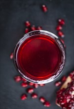 Pomegranate juice on a vintage background as detailed close-up shot (selective focus)