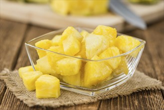 Sliced Pineapple on rustic wooden background as close-up shot