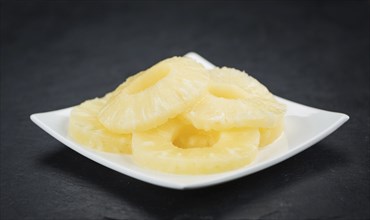 Fresh made Preserved Pineapple Rings on a vintage background as detailed close-up shot