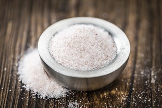 Pink Salt on a vintage background as detailed close-up shot (selective focus)