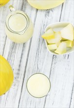 Fresh made Honeydew Melon smoothie (close-up shot, selective focus) on a wooden table