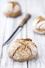 Fresh made Wholemeal Bun on a vintage background (close-up shot)