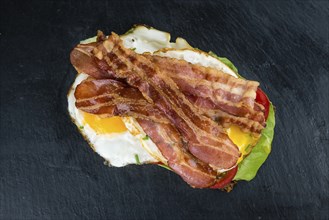 Slate slab with a Bacon and Egg Sandwich (close-up shot)