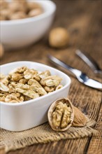 Walnut kernels on a vintage background as detailed close-up shot (selective focus)