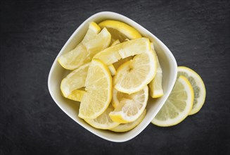 Some fresh Lemon Slices on a vintage slate slab (selective focus, close-up shot)