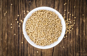 Seeds (Mustard) as high detailed close-up shot on a vintage wooden table (selective focus)