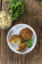 Homemade Falafel (close-up shot, selective focus) on wooden background