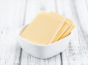 Portion of sliced Cheese (close-up shot, selective focus)